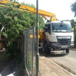 Concrete boom pump extended into difficult access site