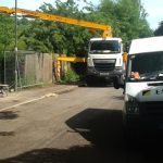 Long-reach concrete boom pump working in a hard-to-reach location