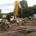 Pouring concrete with a boom pump on a construction site