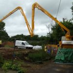 Extended boom on a truck-mounted conctete pump working with limited access