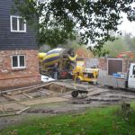 Ready-mix concrete being poured with a static trailer pump